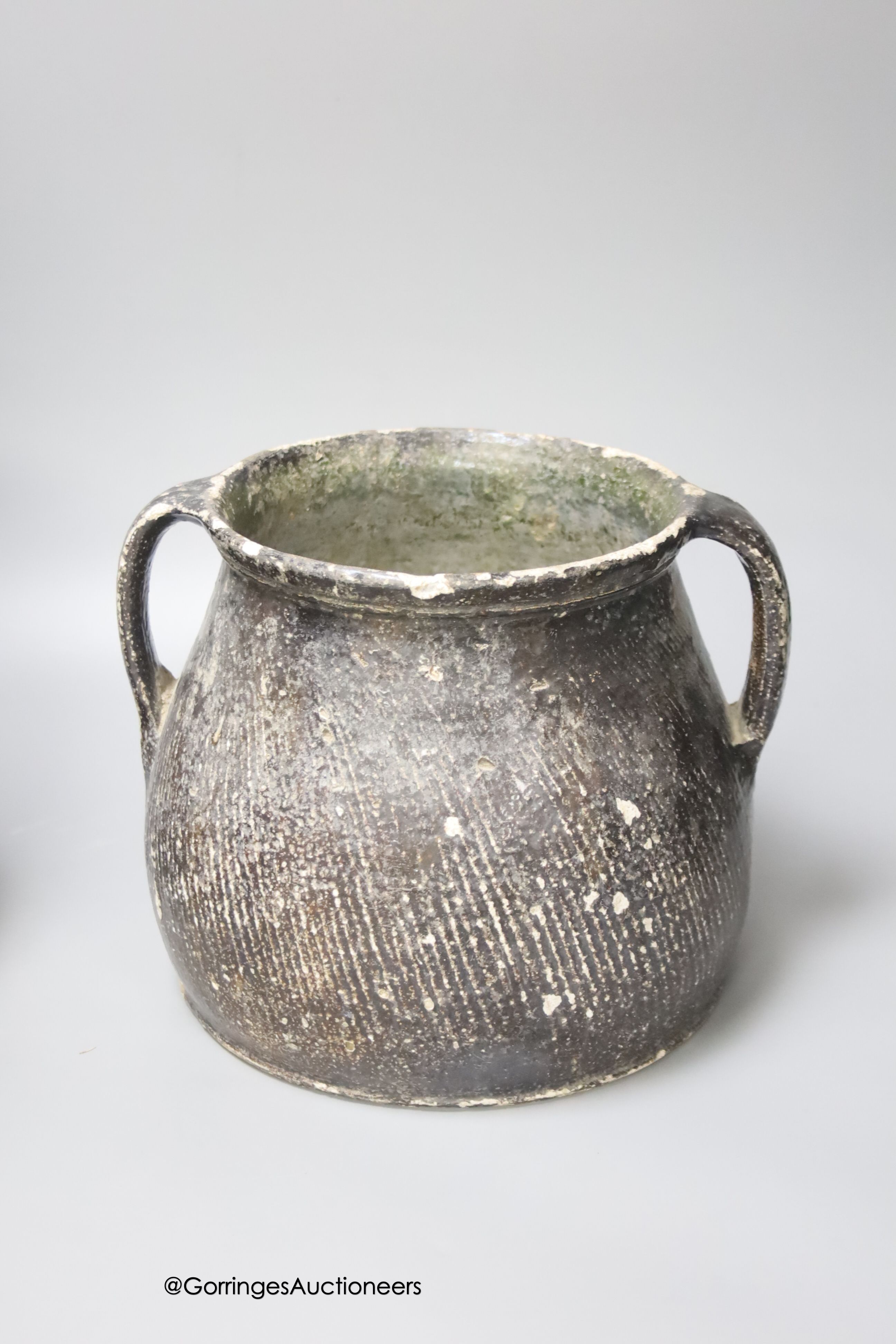 A 17th century continental Tiger ware Bellarmine, 23cm, together with a two handled earthenware bowl, a turned wood bowl and a cylindrical stoneware flask